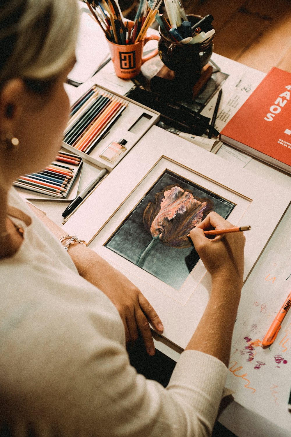 boy in white shirt holding painting