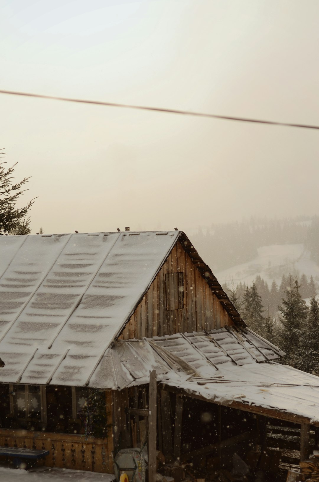 brown wooden house on snow covered ground