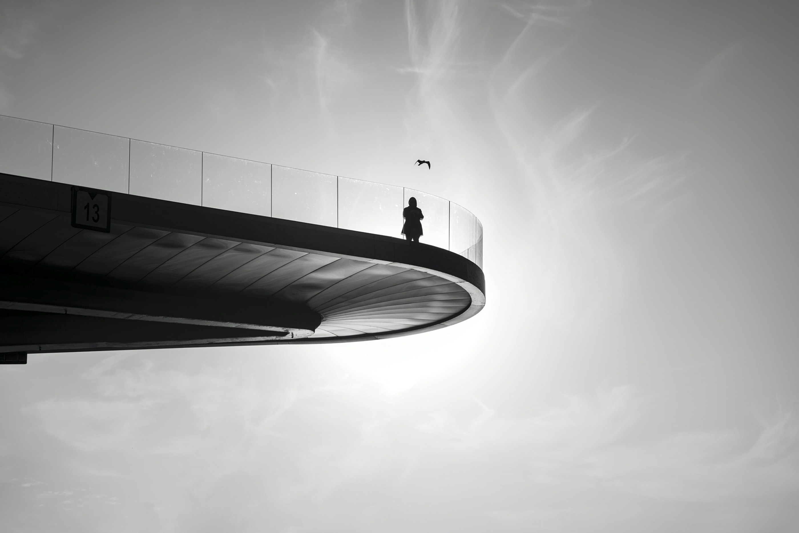 man in black jacket and pants standing on top of building