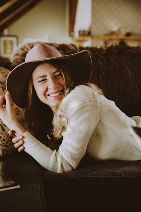 A stylish woman wearing a soft boho chic cardigan, smiling confidently in a sunlit cozy room.