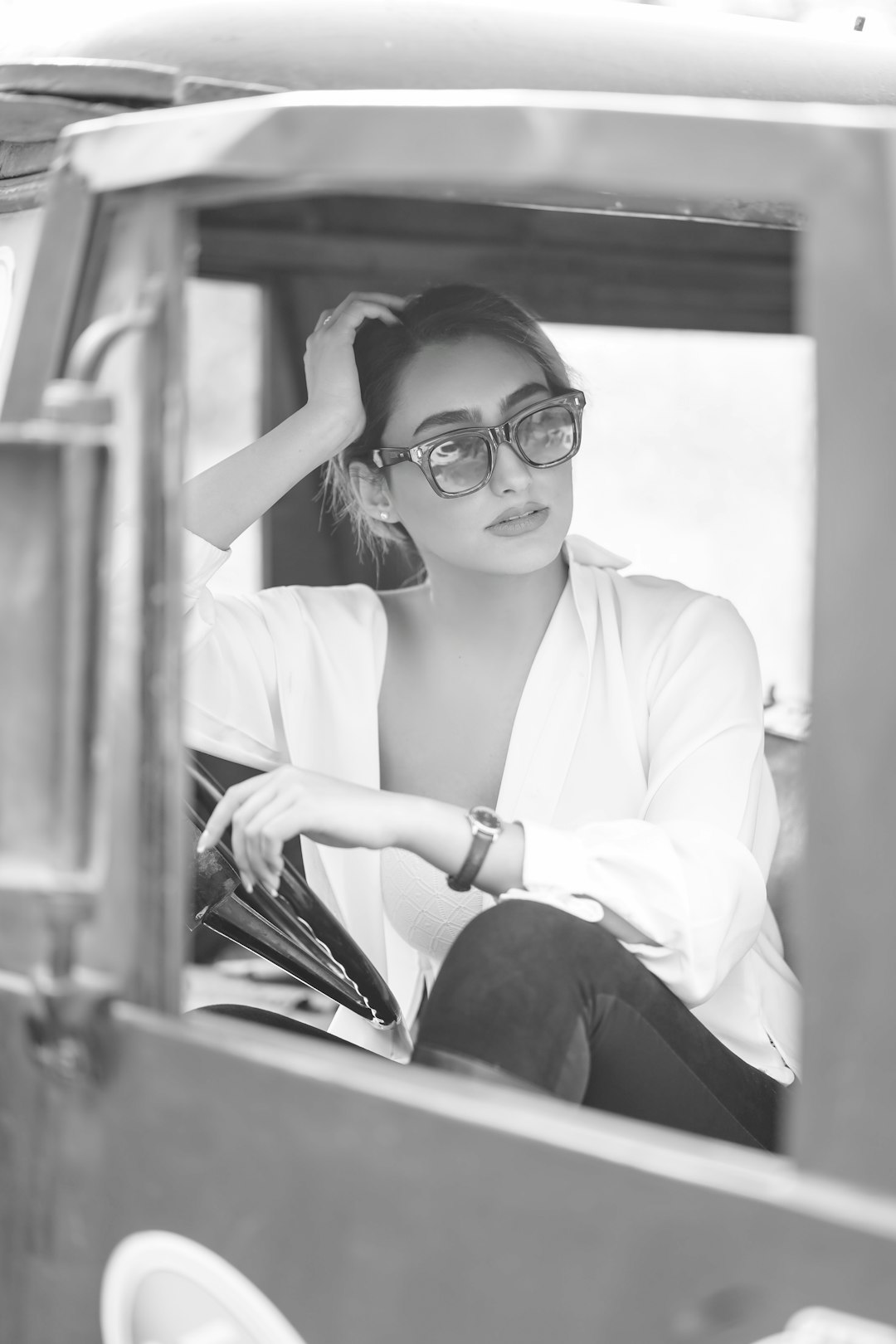 woman in white dress shirt and black pants wearing black framed eyeglasses