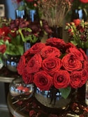 Sophisticated floral centerpiece with a mix of roses and seasonal blooms in a sleek vase