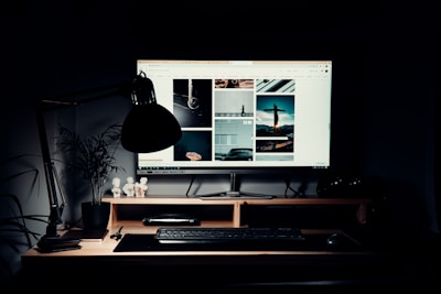 black flat screen computer monitor on brown wooden desk