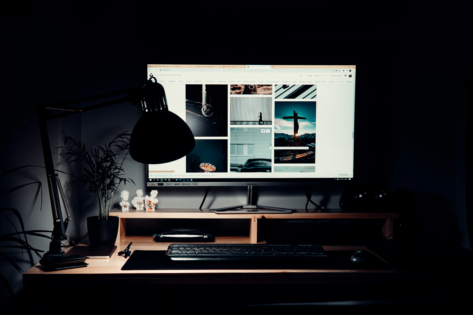 black flat screen computer monitor on brown wooden desk