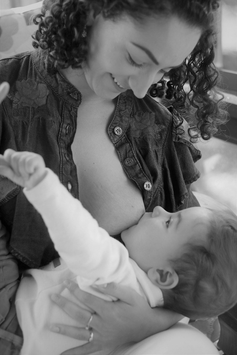 woman in black and white shirt carrying baby in white long sleeve shirt