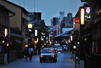 people walking on sidewalk during night time