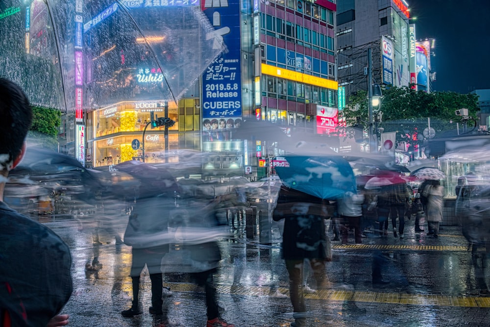 person in black jacket holding umbrella walking on sidewalk during rain
