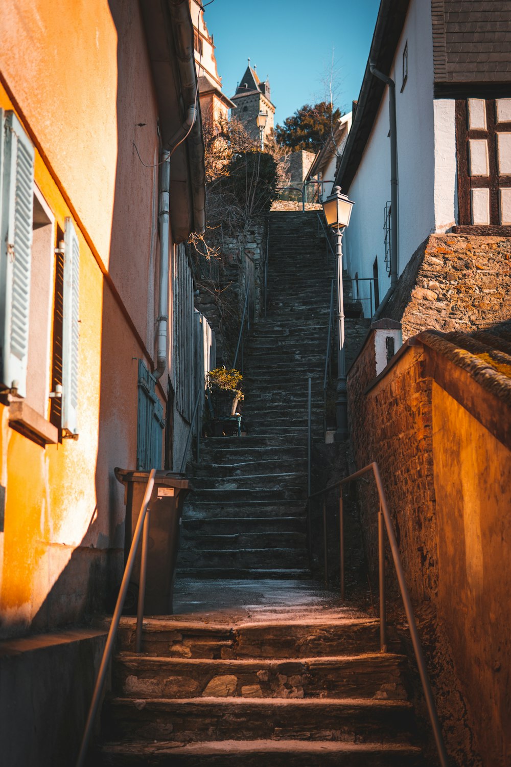 brown wooden ladder leaning on brown brick wall