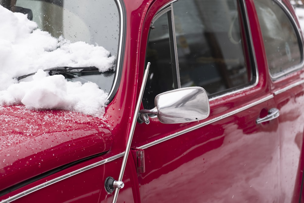 red car with white snow