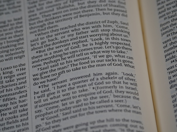 A close-up view of an open book displaying a passage of text. The text is printed in a well-defined serif font and arranged in a two-column layout. The right-hand page is partially visible, and it appears that the book is in English.