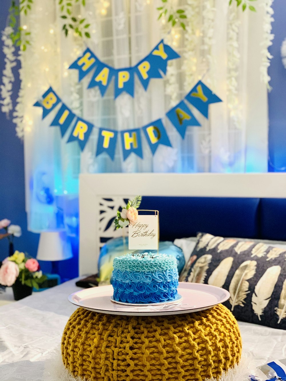 blue and white floral cake on brown wooden round table