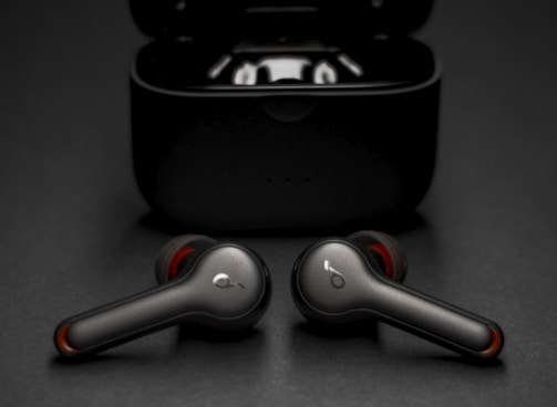 black and silver wireless earbuds