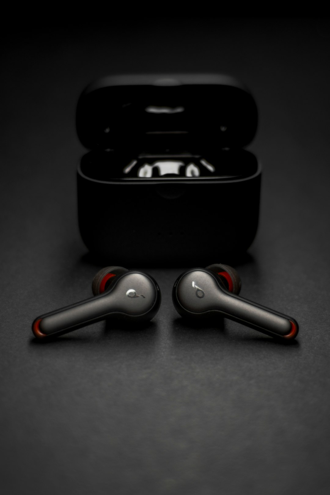 black and silver wireless earbuds