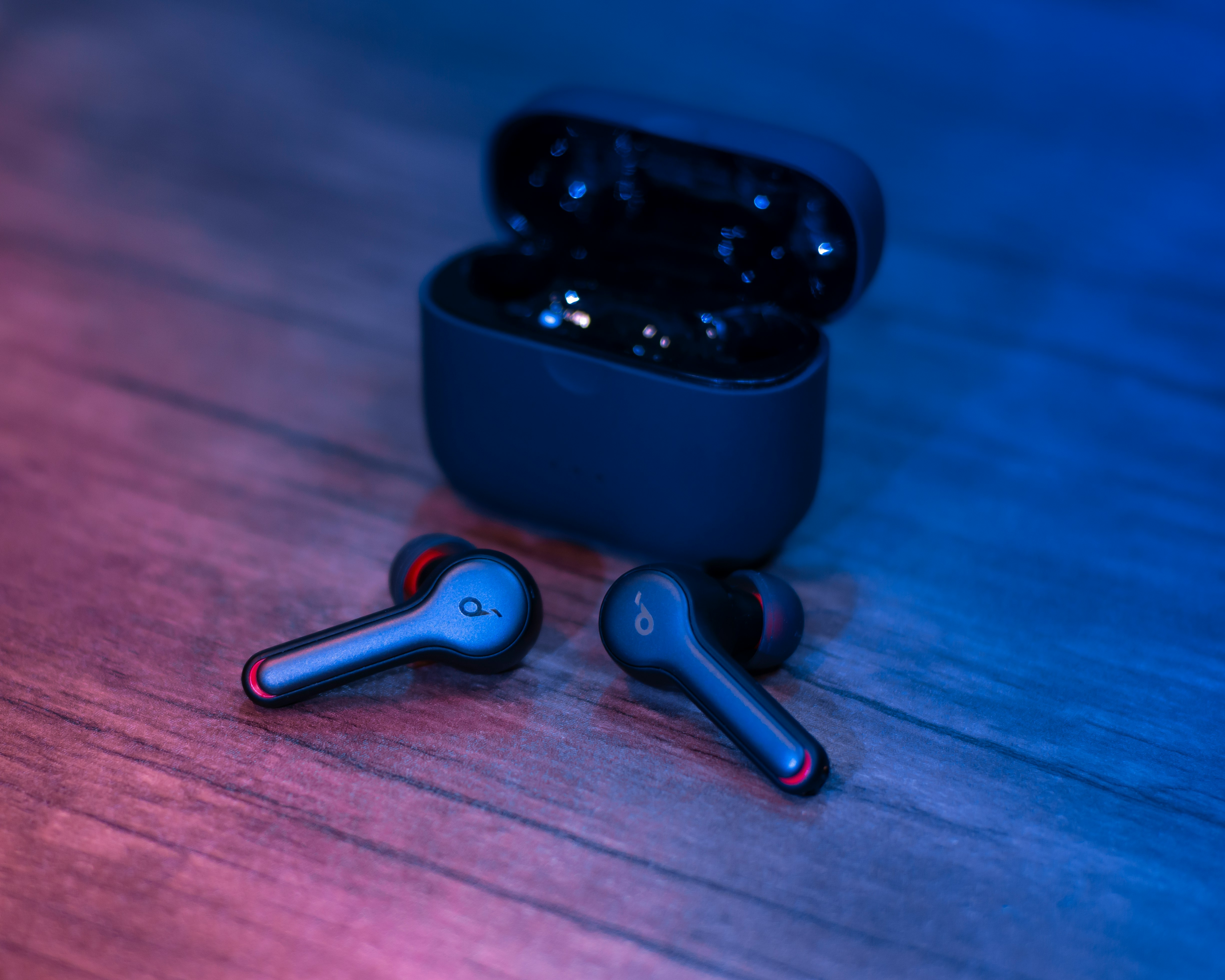 black and silver bluetooth earbuds