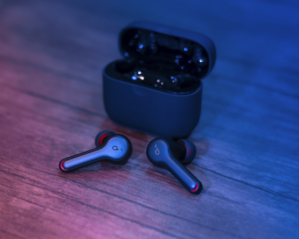 black and silver bluetooth earbuds