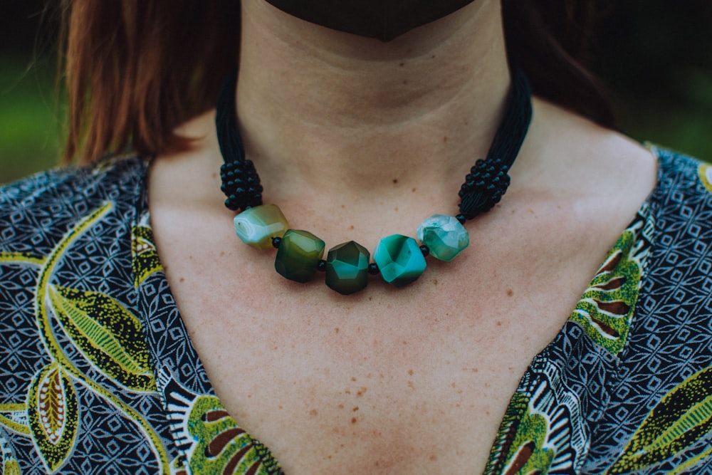 woman wearing green and silver beaded necklace