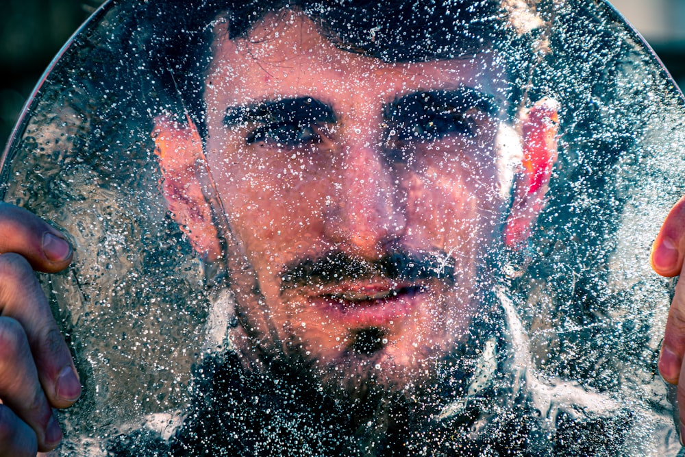 mans face on water
