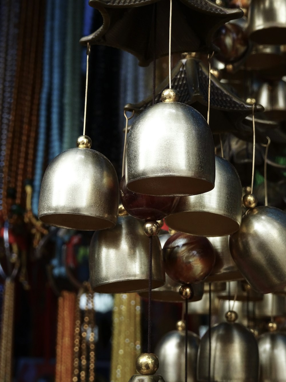 silver and gold bell hanging on brown wooden wall