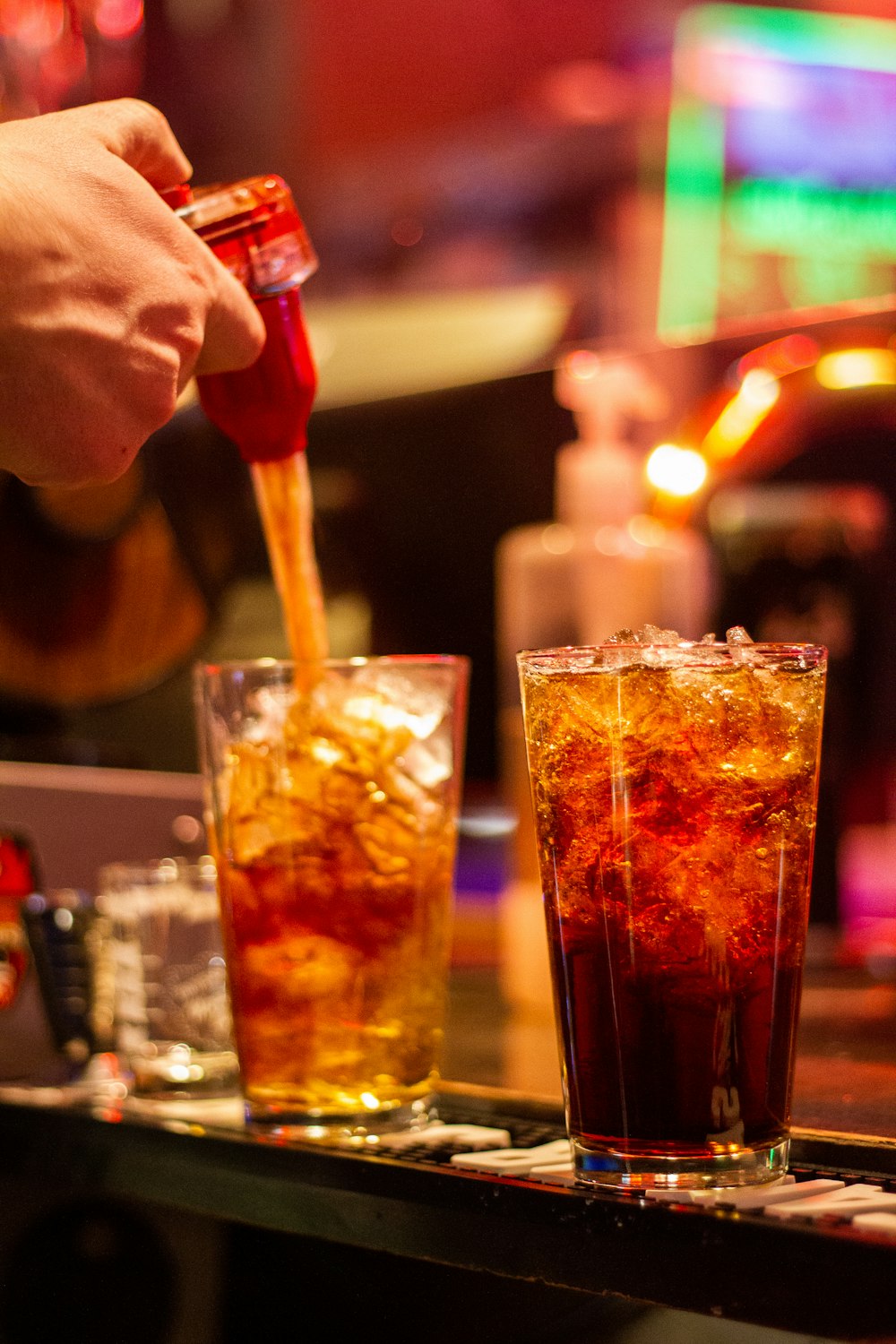 clear drinking glass with orange liquid and ice