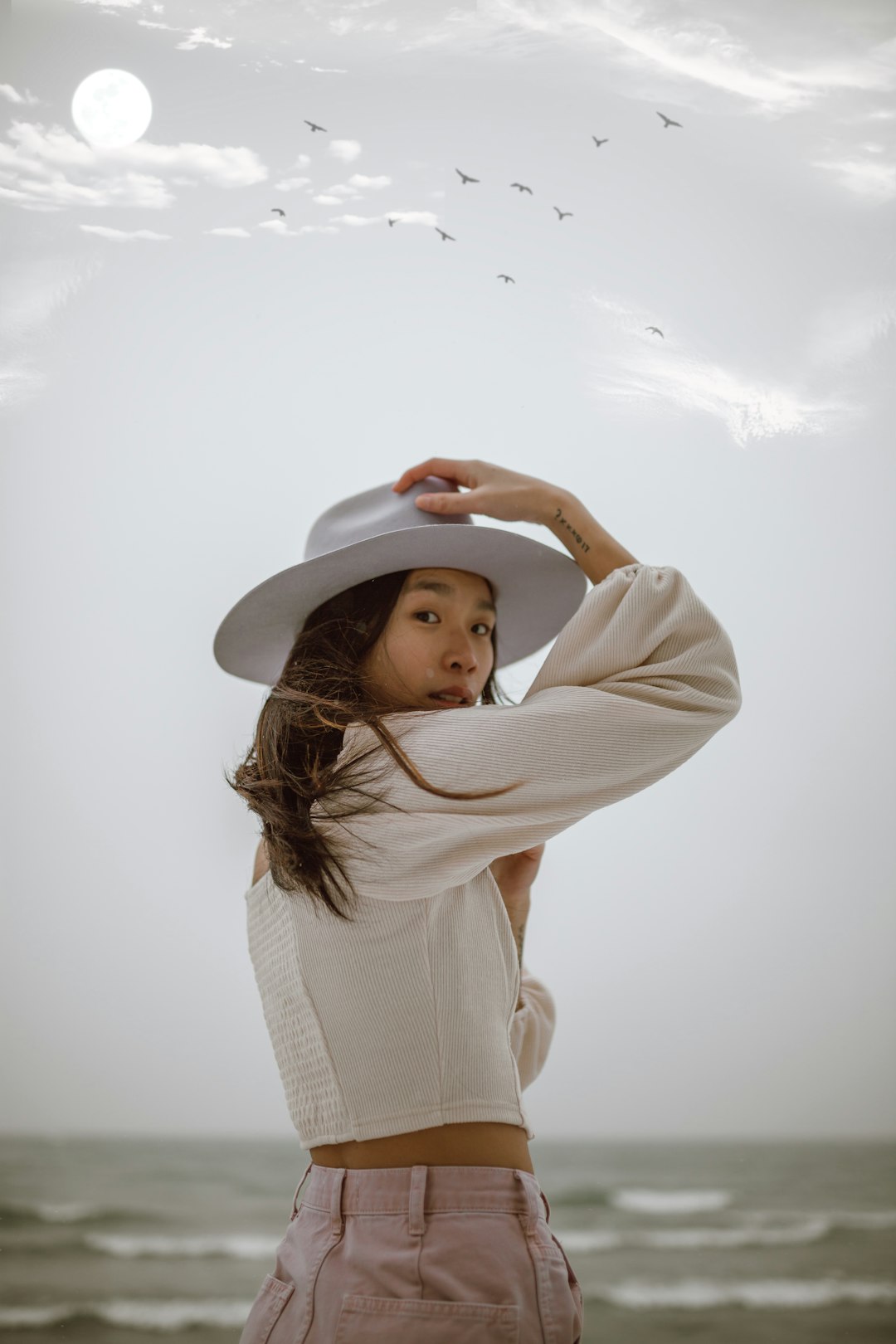 woman in white long sleeve shirt wearing white hat