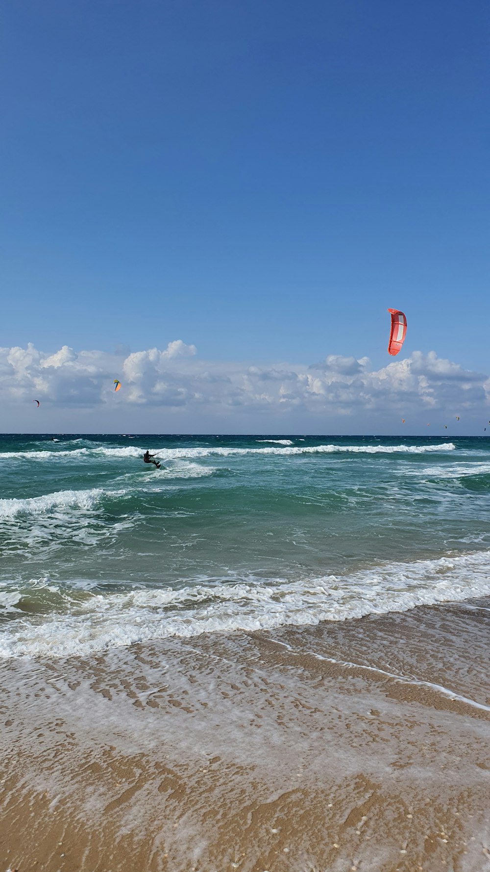 people surfing on sea waves during daytime