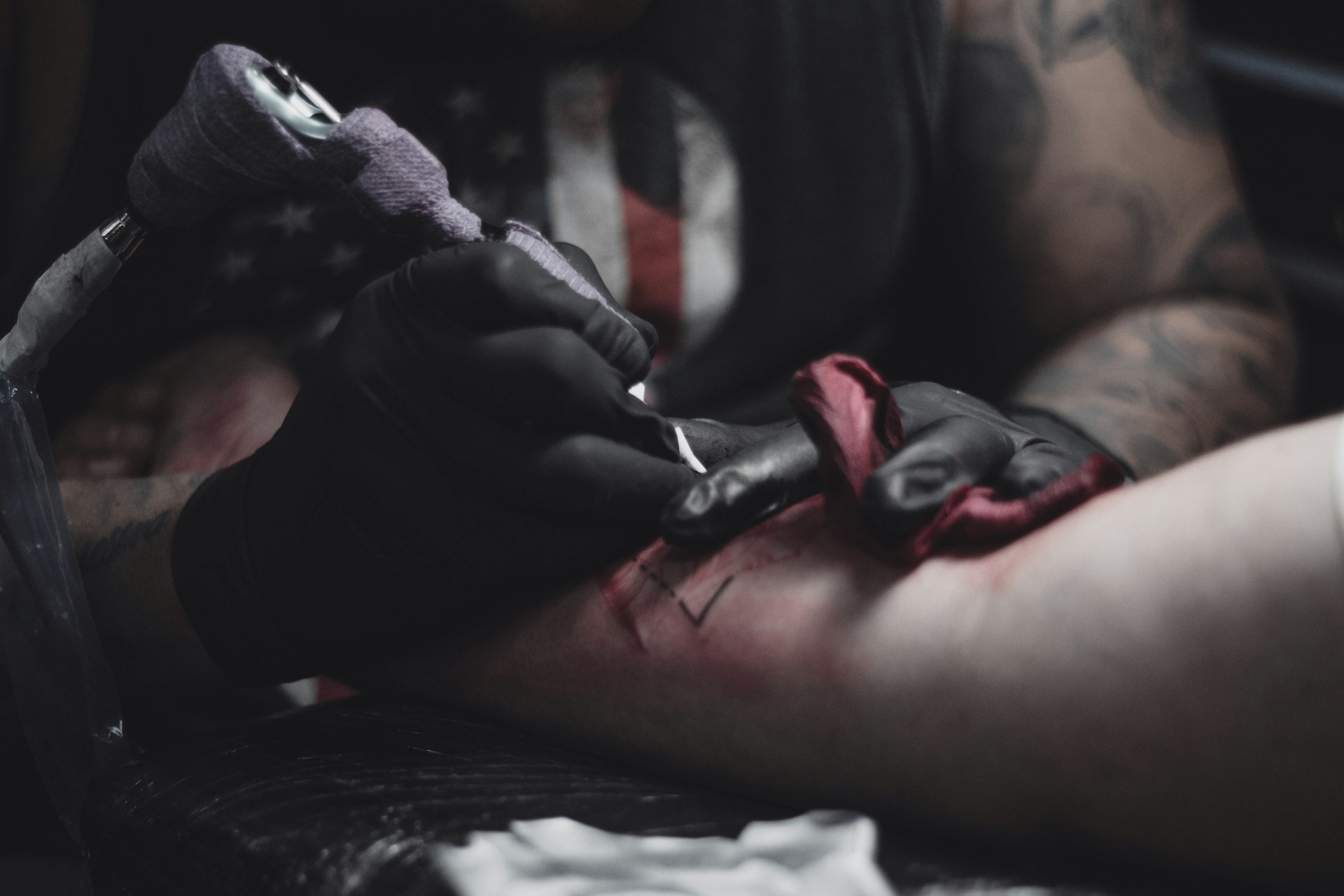 person in black jacket lying on bed
