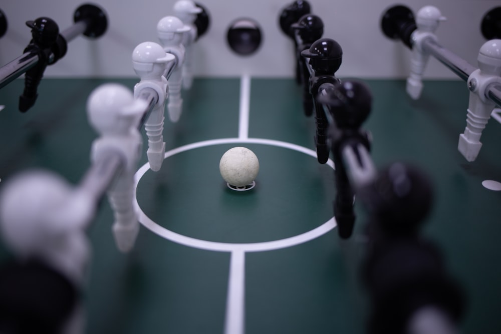 white and black soccer ball on green and white court