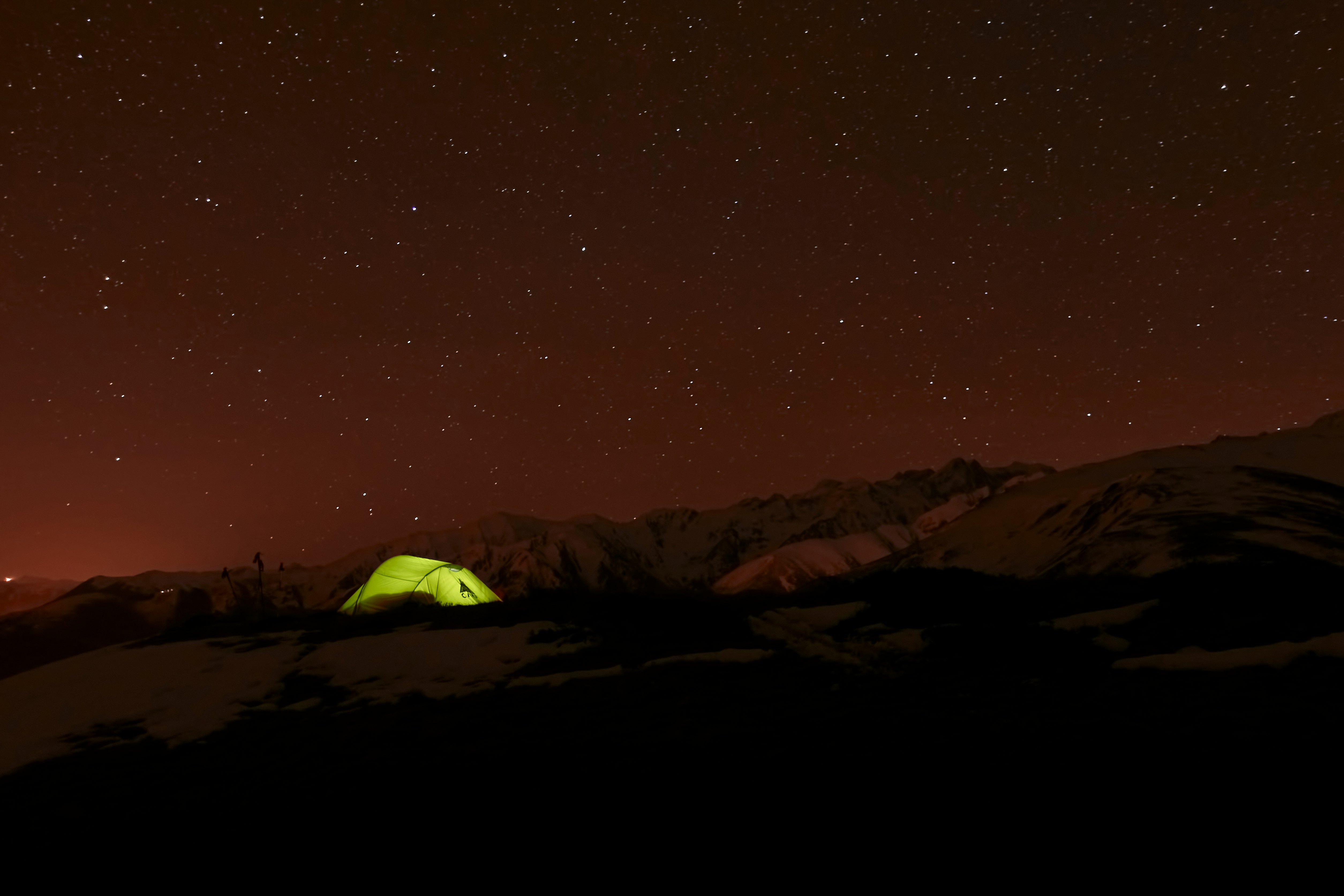 green tent on brown field during night time