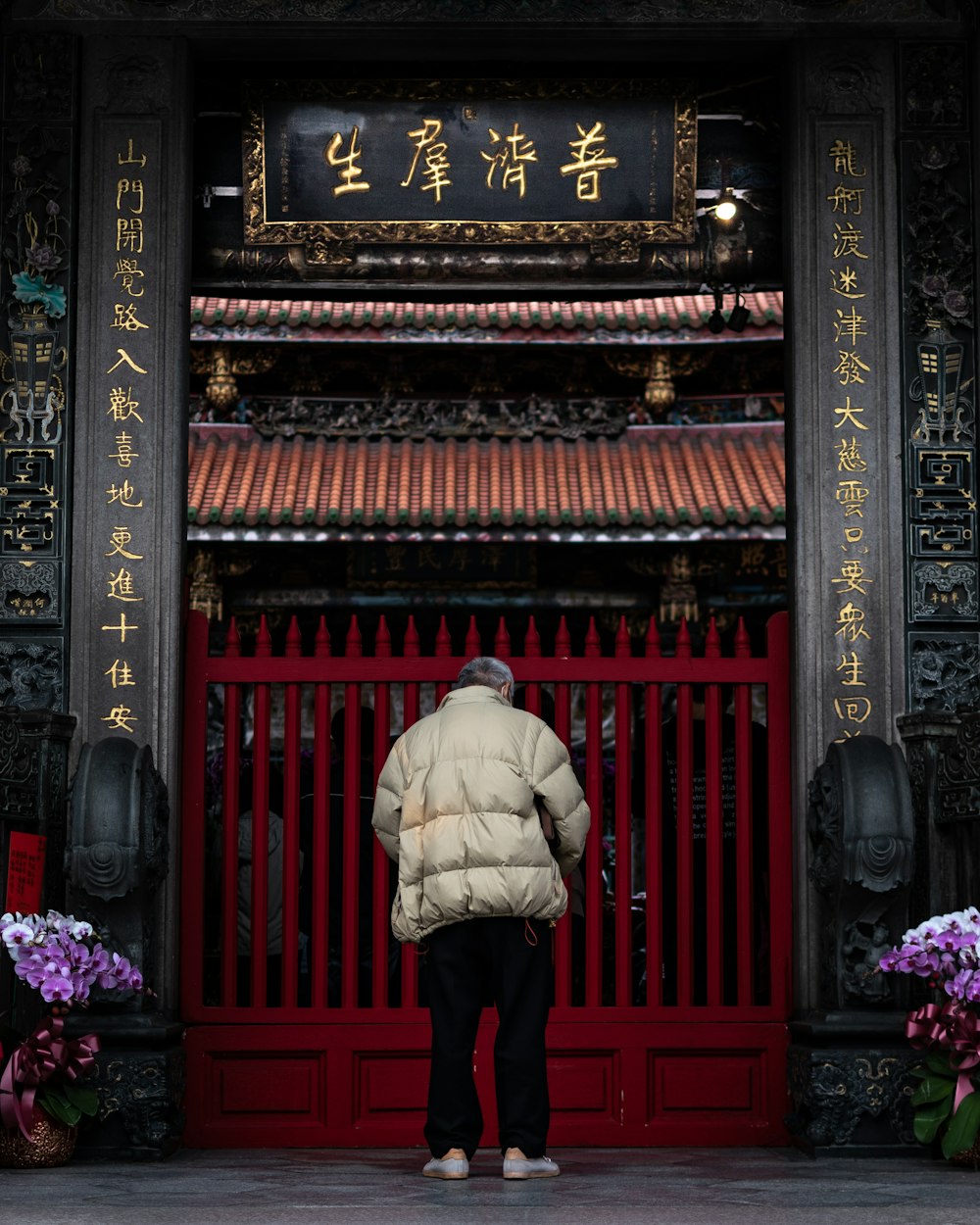 woman in brown coat standing in front of brown wooden door