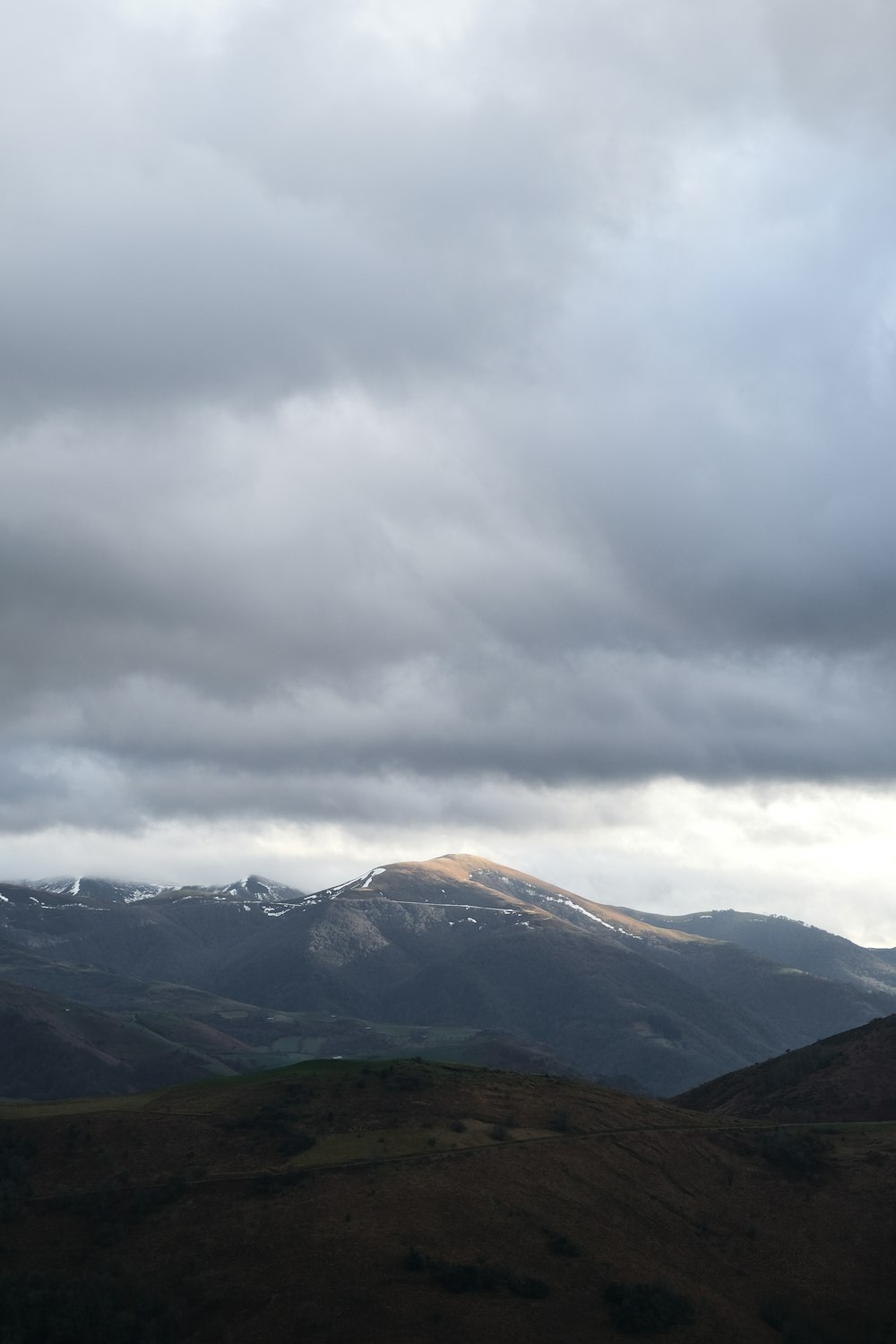 green and brown mountains under white clouds during daytime