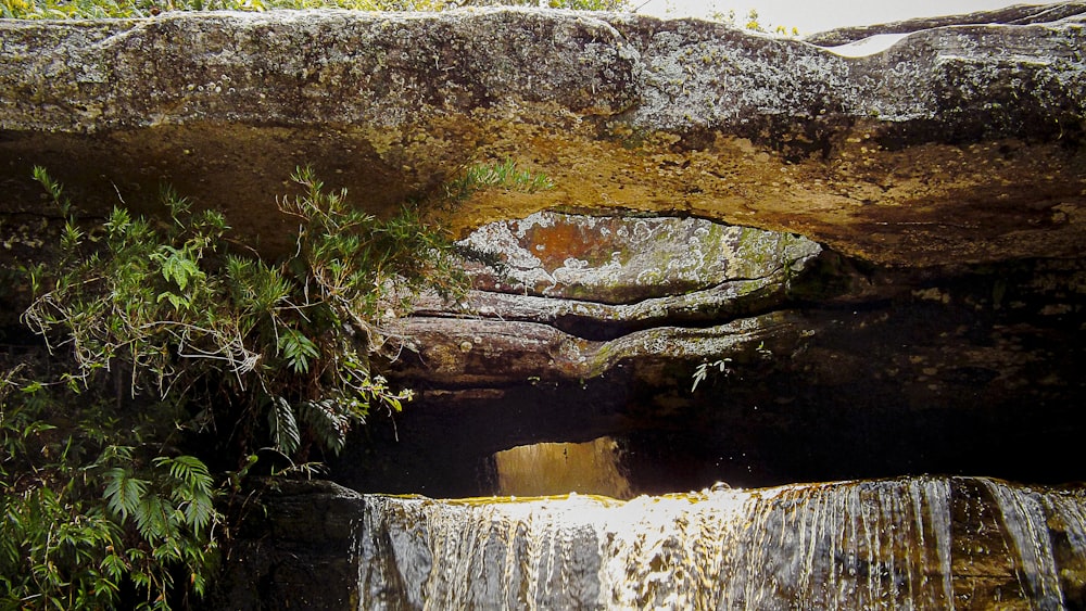 brown rock formation near body of water during daytime