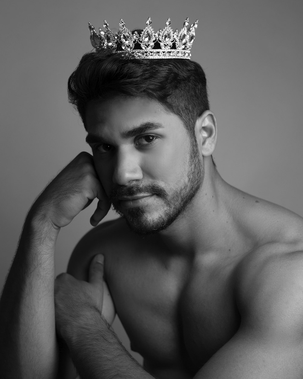 topless man with silver and black crown