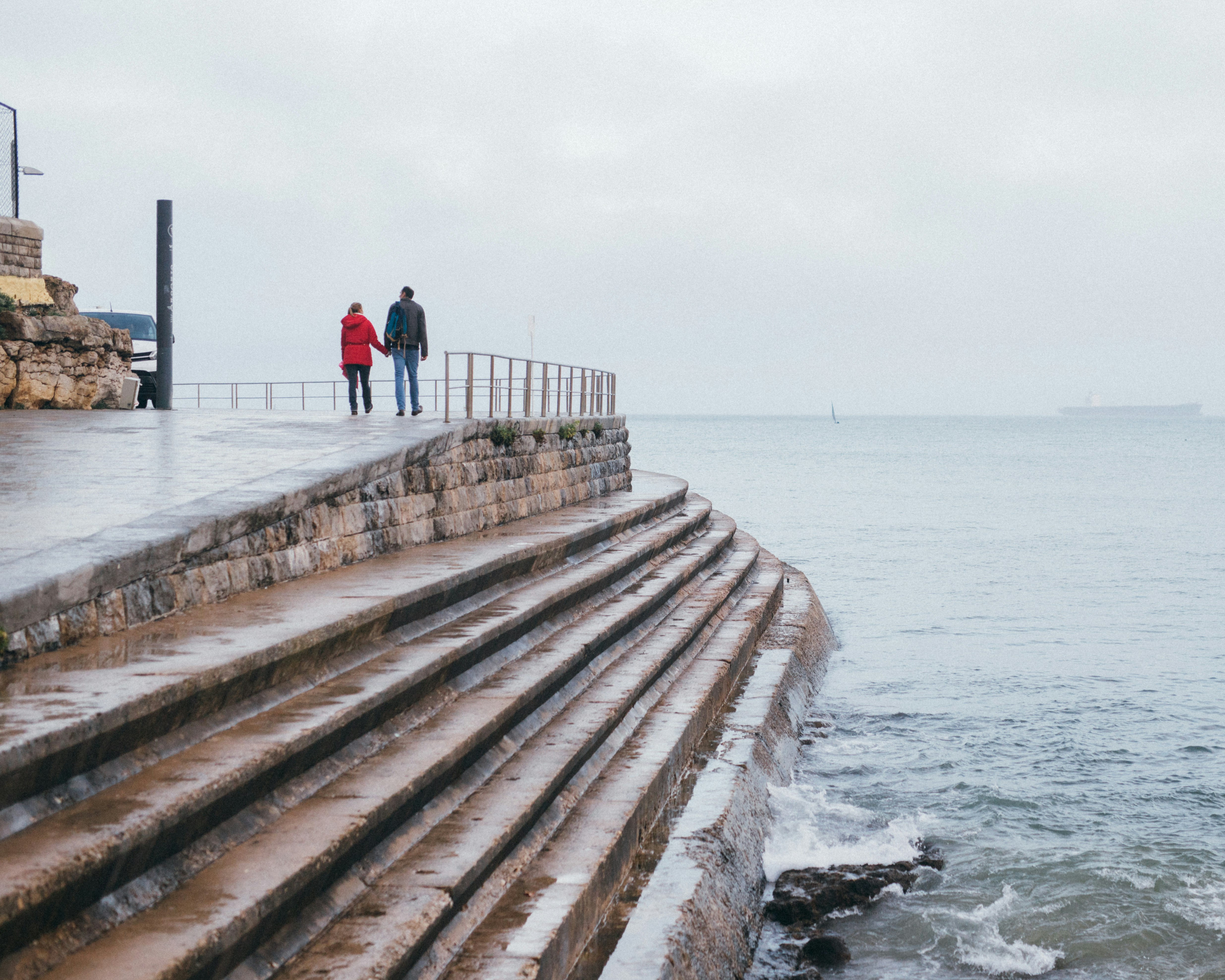 people walking on wooden dock near sea during daytime