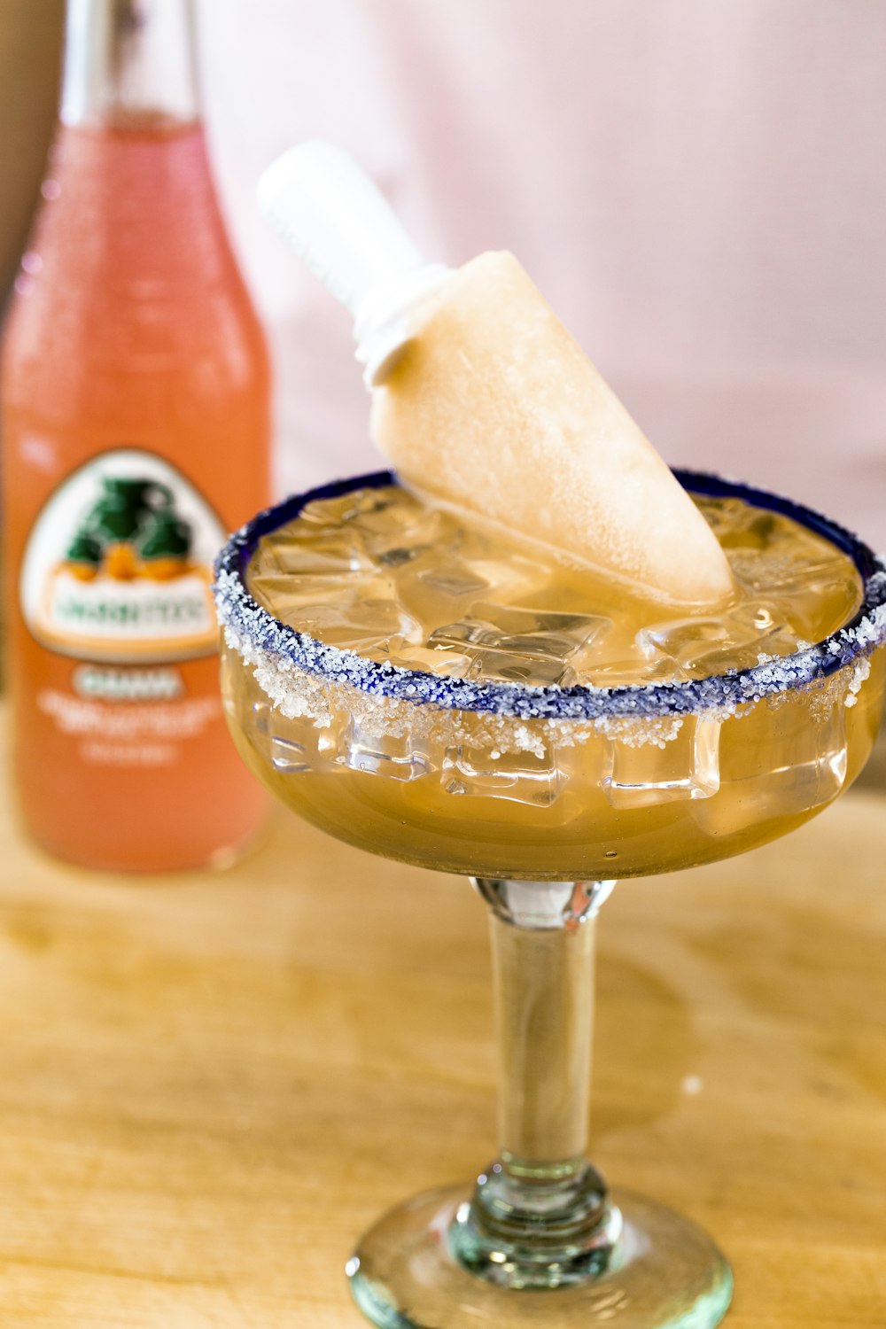 clear drinking glass with ice and orange juice