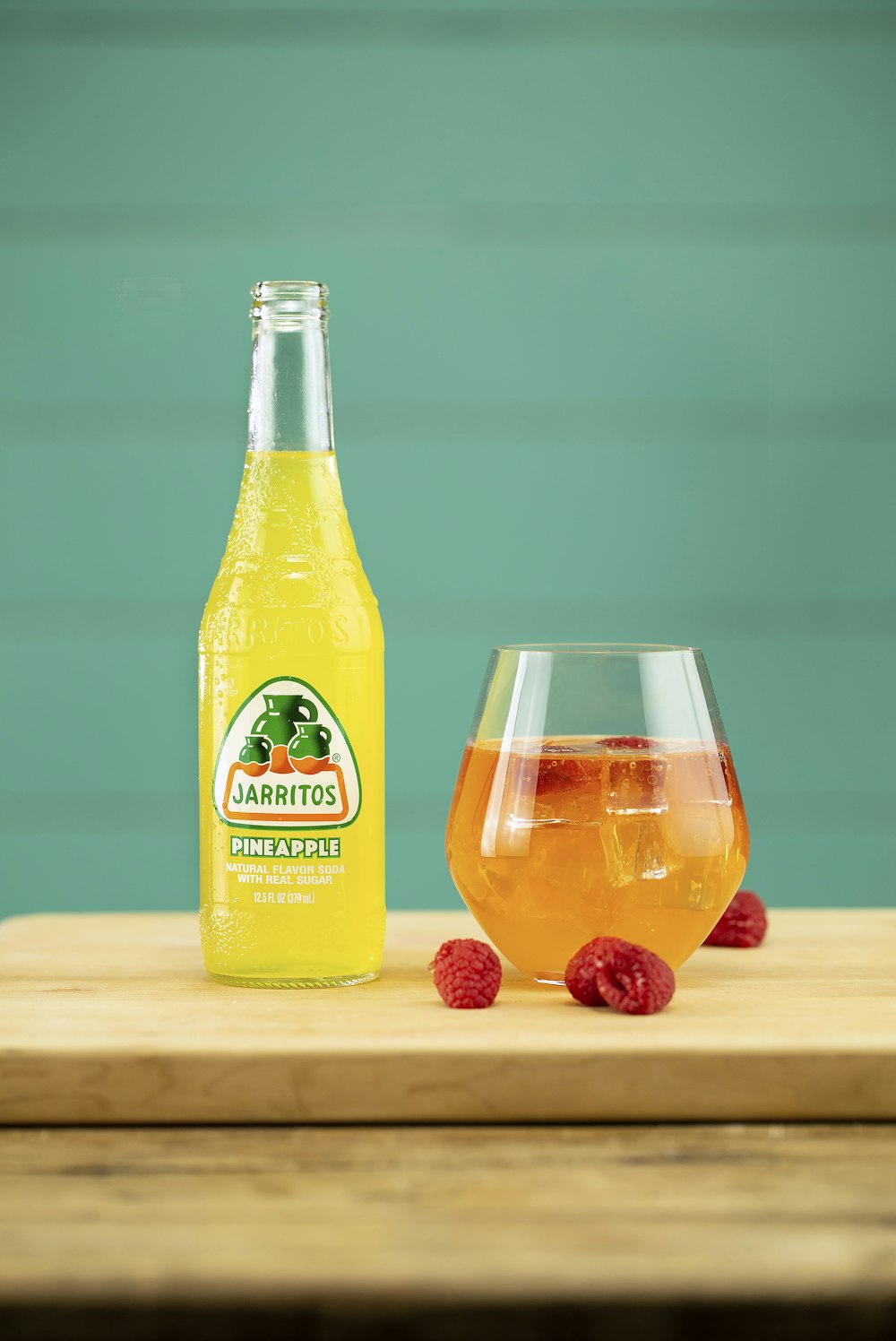 orange juice bottle beside clear drinking glass