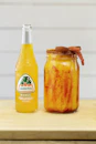 clear glass bottle with yellow liquid inside