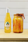 clear glass bottle with yellow liquid inside