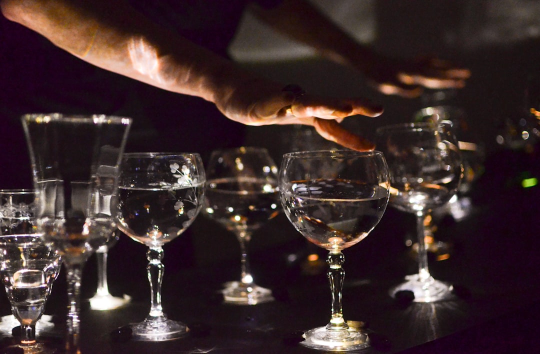 person holding clear wine glass