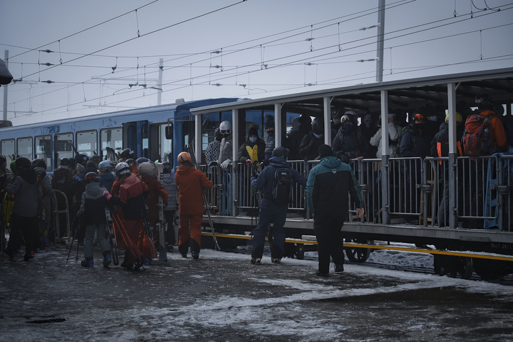 people in green and white train during daytime