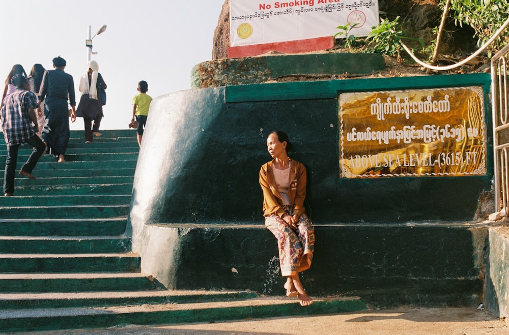 woman in brown dress standing on stairs during daytime