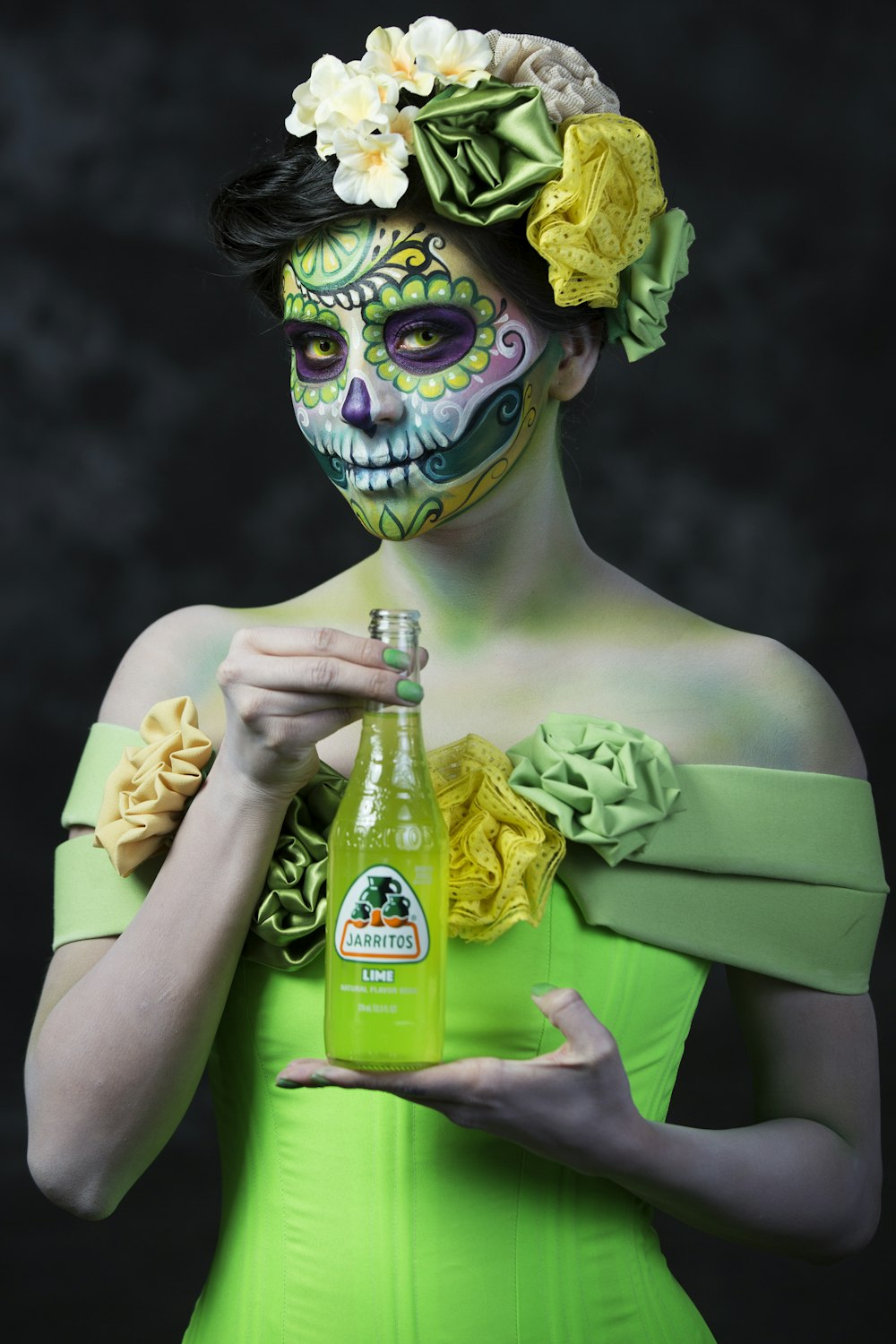 woman in green dress holding green bottle