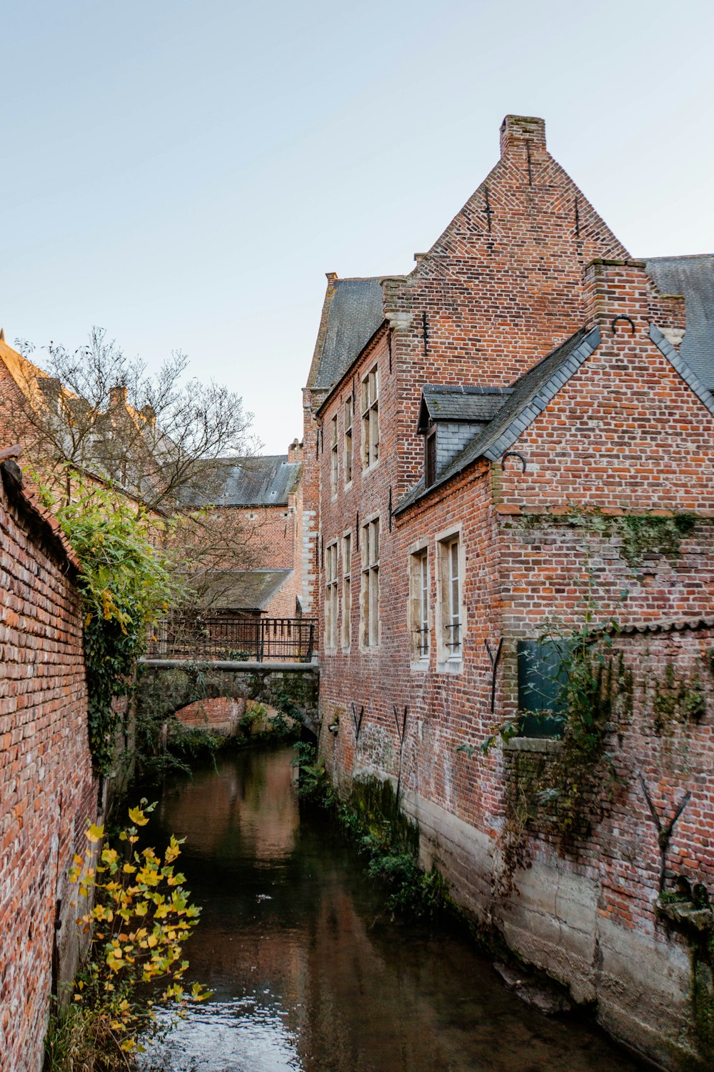 brown brick building beside river during daytime