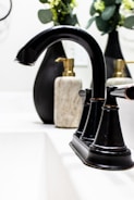 Close-up of elegant bathroom accessories including soap dispensers and towel racks