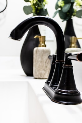Close-up of modern bathroom faucets with a blue and gray color theme.