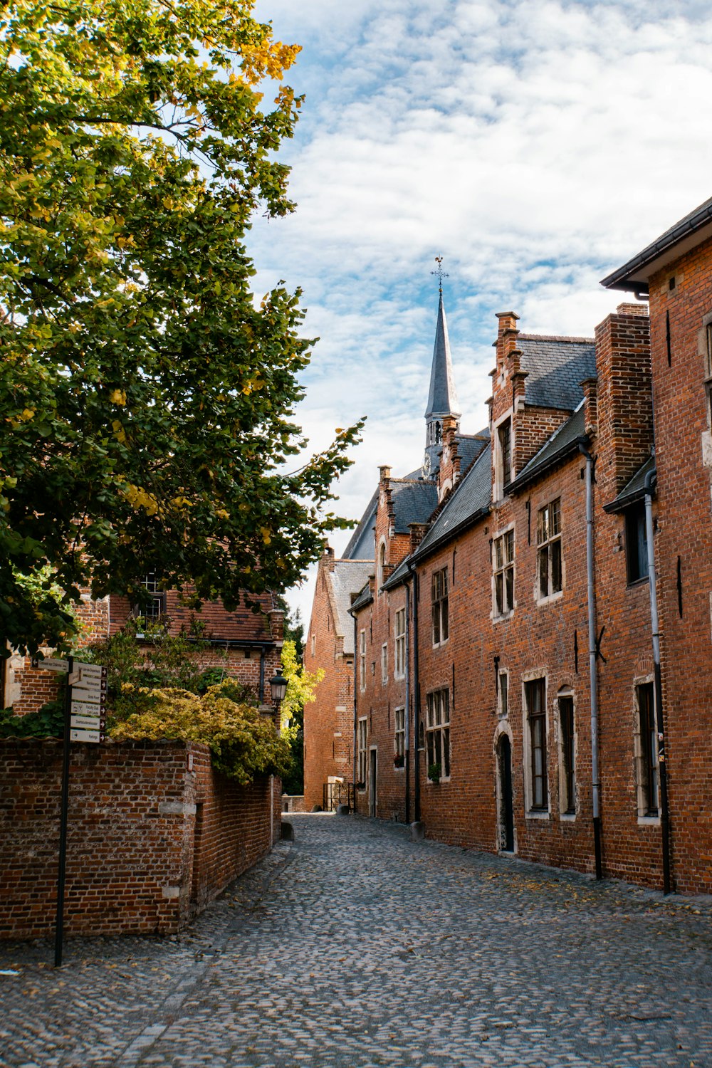 brown brick building near green trees during daytime