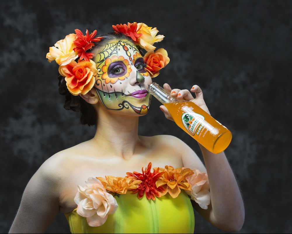 woman in yellow tube top holding orange and yellow flower bouquet