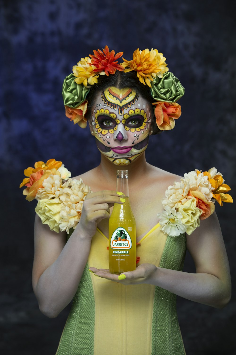 Mujer con tocado floral amarillo y verde sosteniendo botella de flores amarillas