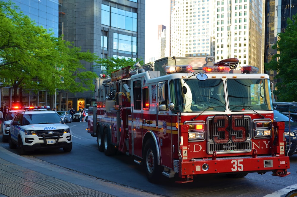 red and white fire truck on road during daytime