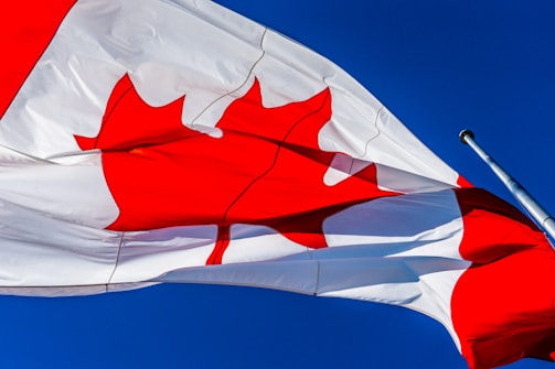 white and red flag under blue sky during daytime