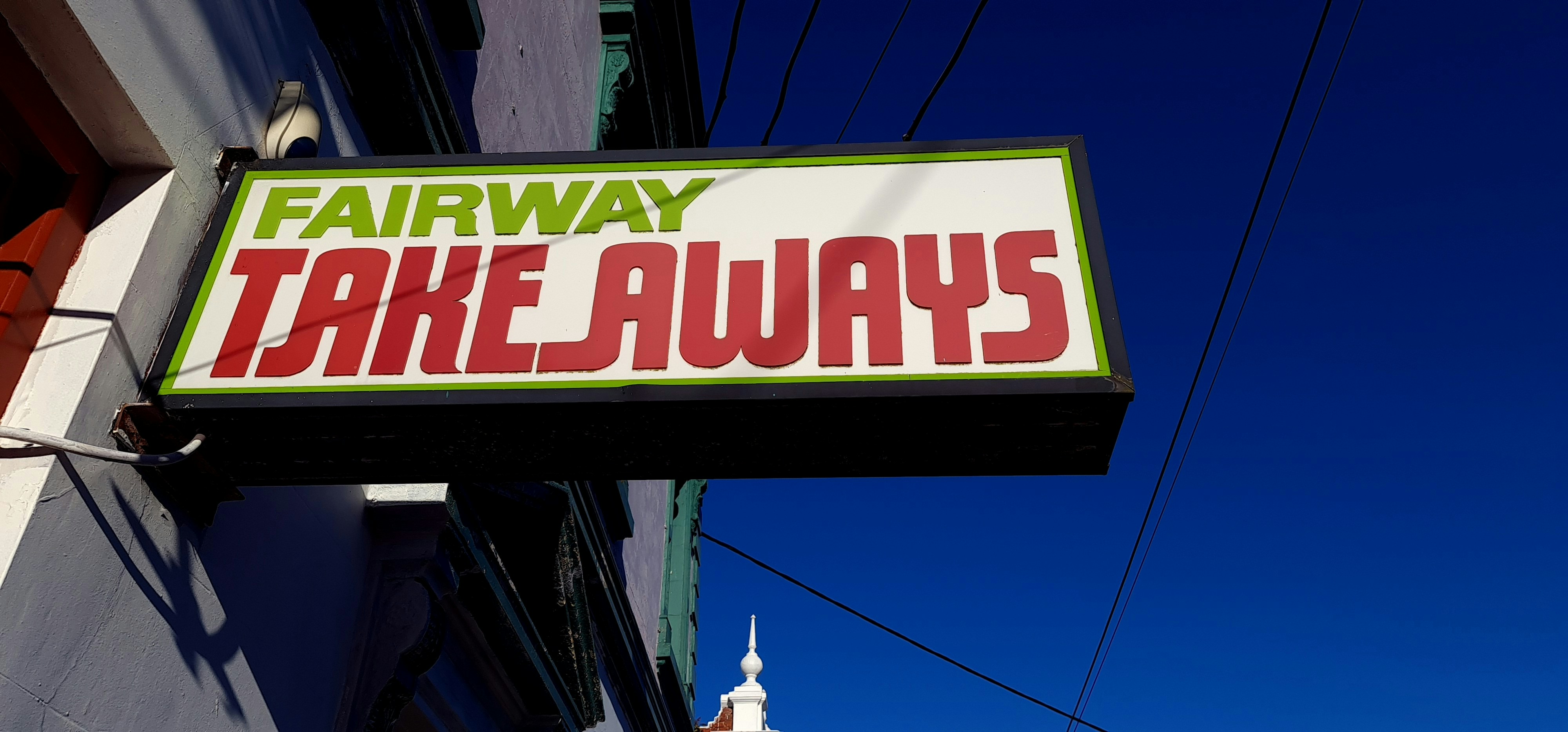 white and green UNKs coffee store signage